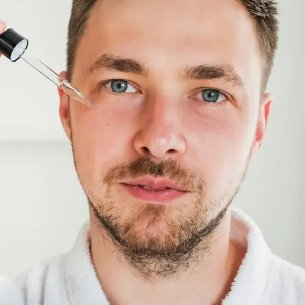 Man Applying Serum on Face